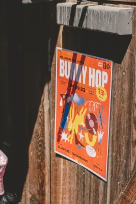 A picture of a poster for the Bunny Hop attached to a wood wall.