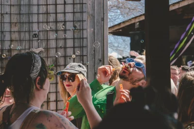 A picture of a group of people. Over their heads is a stream of bubbles.
