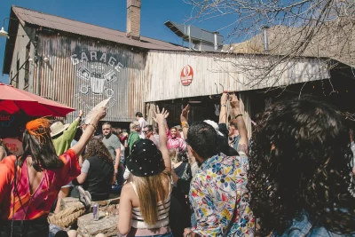 A crowd of people raising their hands greeting the event's special guest, BoyaBADDIE.
