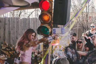 BoyaBADDIE holding a bubble gun and spraying bubbles into the audience.