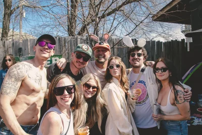 A group shot of people. They are all looking at the camera and smiling.