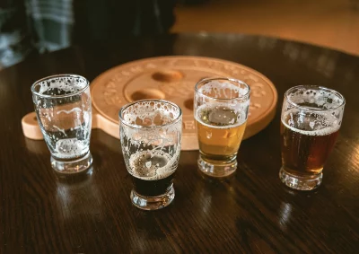 Four beer glasses sit on a table. Each are filled with varying amounts of different Hopkins beers. Photo: Bonneville Jones