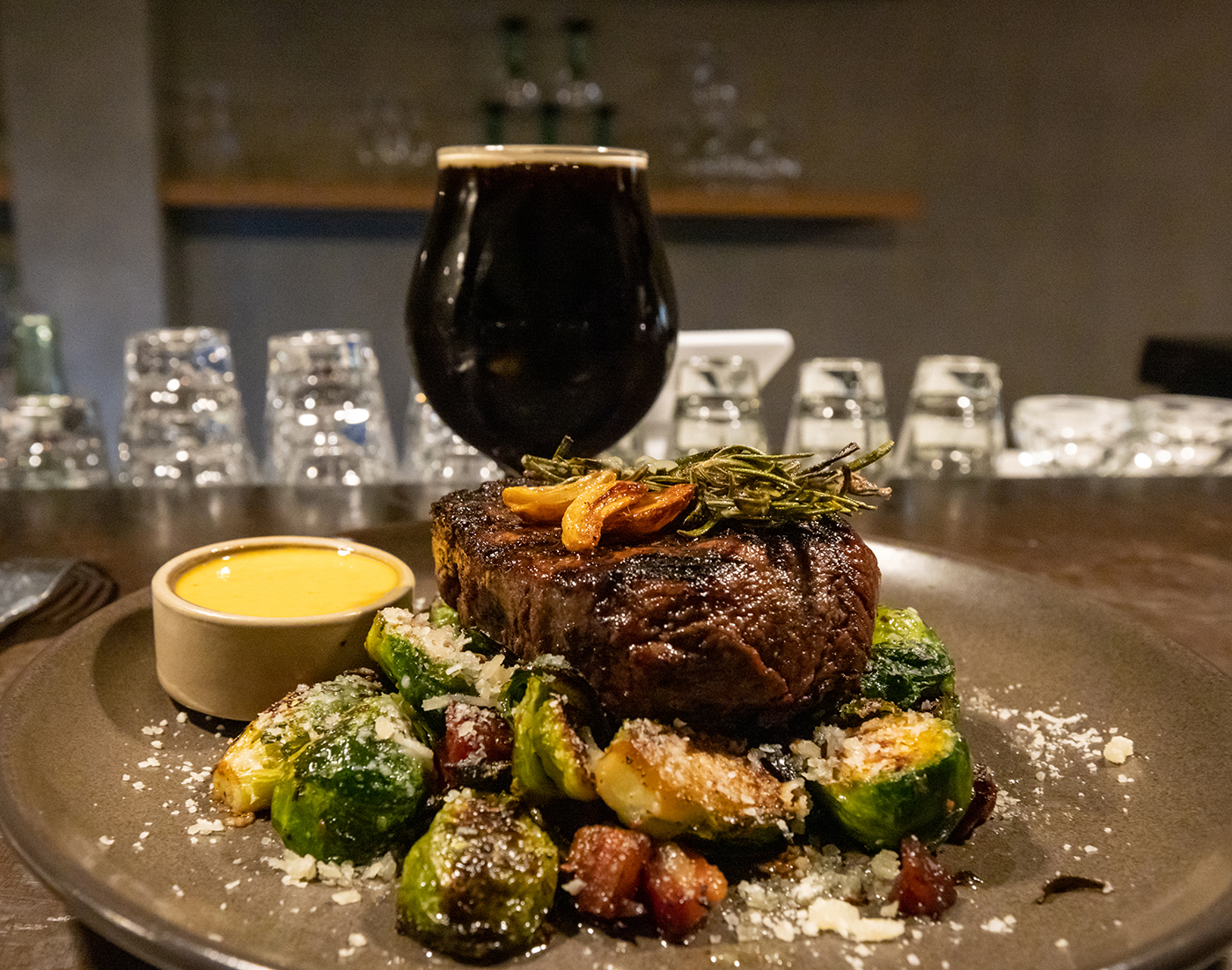 Filet mignon, roasted Brussels sprouts, crispy pancetta and chile Béarnaise paired with a pint of the Emigration Stout brewed by Moab Brewery.