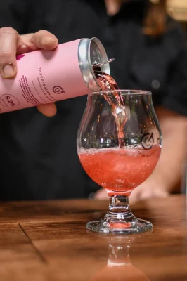A red-cherry seltzer is proured into a beer glass. Photo: Em Behringer