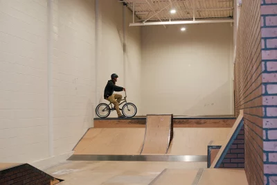 Pictured is a person on a bike halfway through an indoor BMX course at Neptune Skating. Photo: Lexi Kiedaisch