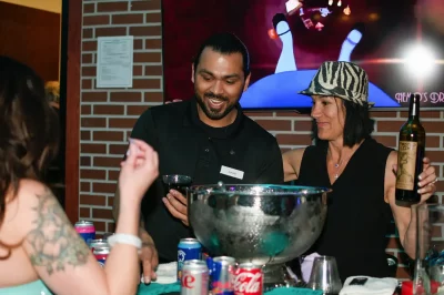 Zohaib getting the drinks flowing for Queer Wonderland. Photo: Em Behringer