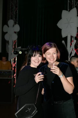 Grace Heinz (she/her) and Lola Riley (she/they) taking a break from the dance floor to rehydrate! Photo: Em Behringer