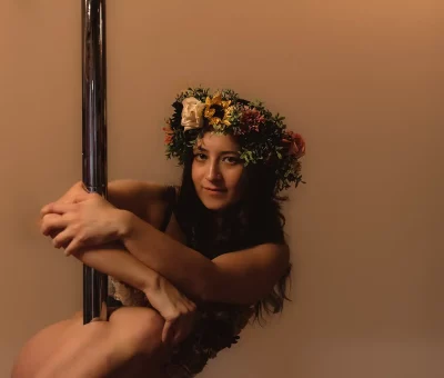 Lexa Leigh wears a flower crown while holding onto her pole. Photo: Bonneville Jones