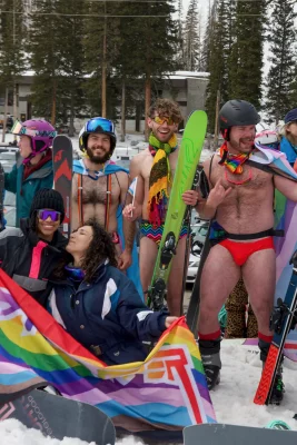 Several people stand barely clothed in the snow, ready to have their photo taken. Photo: Jovvany Villalobos