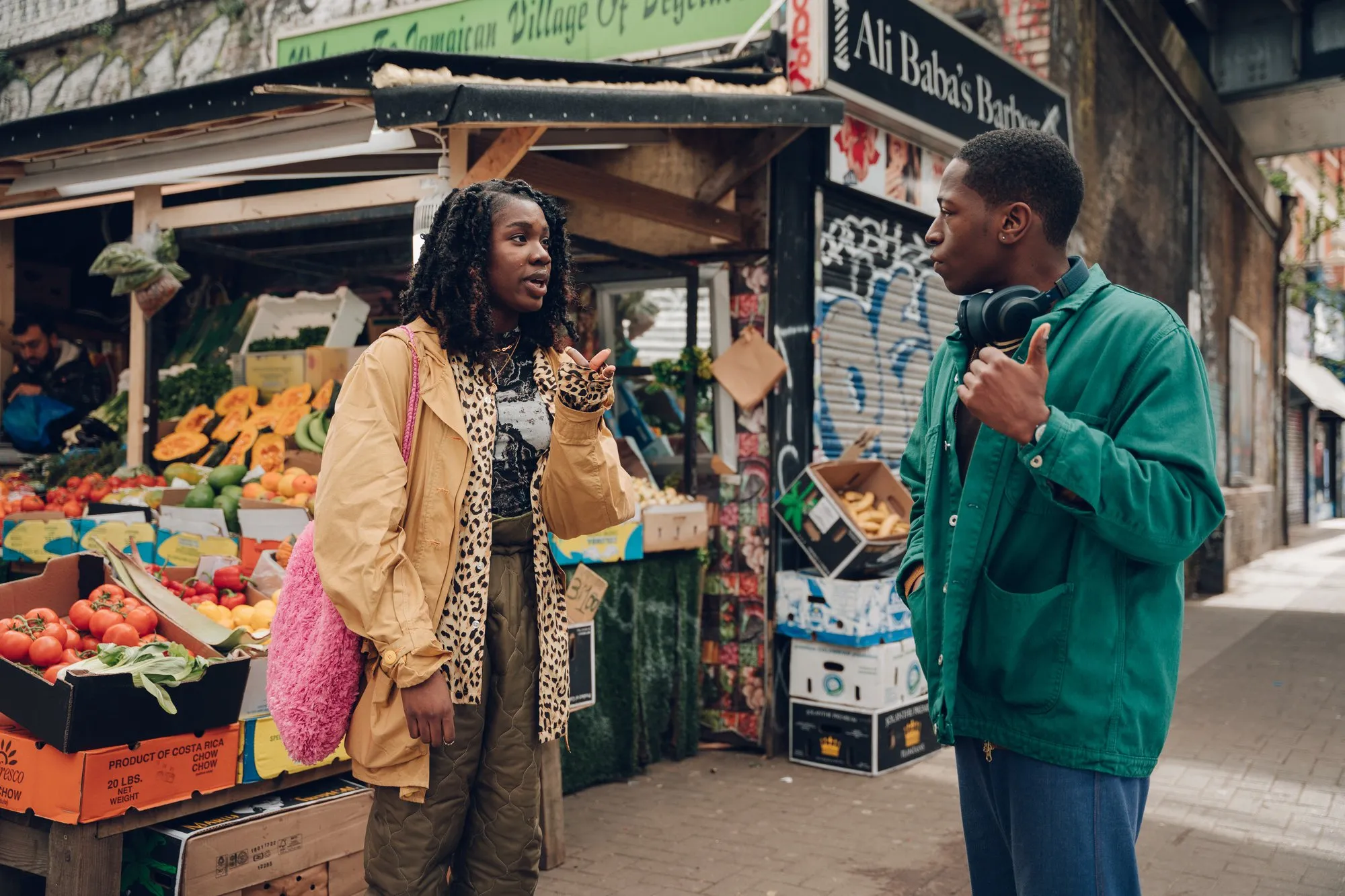 Vivian Oparah and David Jonsson stand talking at a street corner in South London in the film Rye Lane. Photo courtesy of Searchlight Pictures.