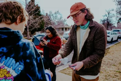 Jacob Brooks converses with the public, as he passes out stickers and chats with bystanders.