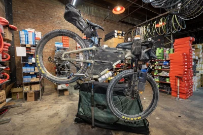A mountain bike and an attached bag is suspended at Cranky's Bike Shop. Photo: John Barkiple