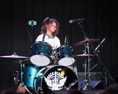 A member of Rock Camp SLC plays drums onstage. Photo: Sam Crump (Courtesy of Rock Camp SLC)