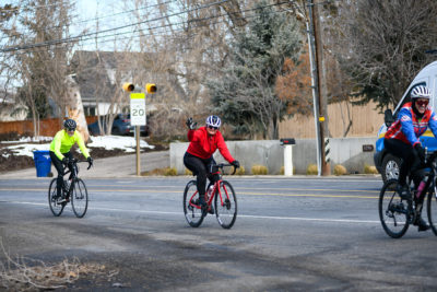 Bonneville Cycling Club Cyclists wave to the camera during a ride. Photo: Em Behringer