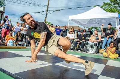 A breakdancer sticks his tongue out mid-dance. Photo courtesy of 1520 Arts