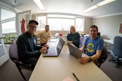 The O2 Utah team sit around a table and look at the camera. Photo: Chay Mosqueda