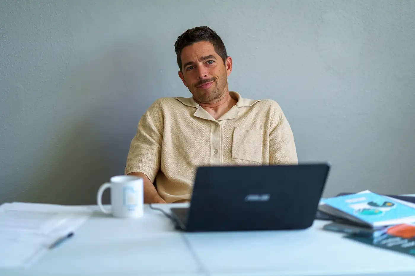 David Garbett of O2 Utah sits at his desk with a laptop in front of him.