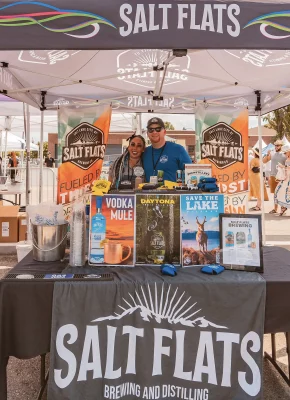 Two people working at the Salt Flats booth.