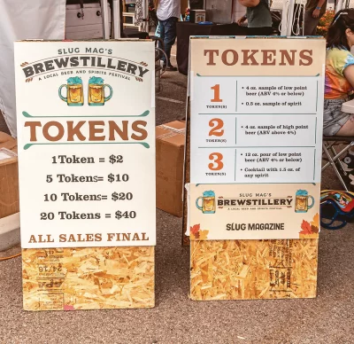 Two signs displaying prices of Brewstillery tokens.
