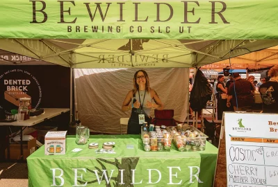 A person working the Bewilder Brewing Company booth.