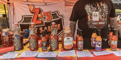 a close up of numerous hot-sauce bottles.