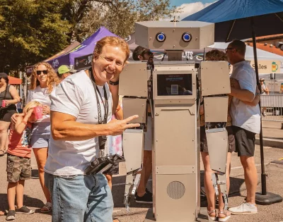 A person standing in front of a robot.
