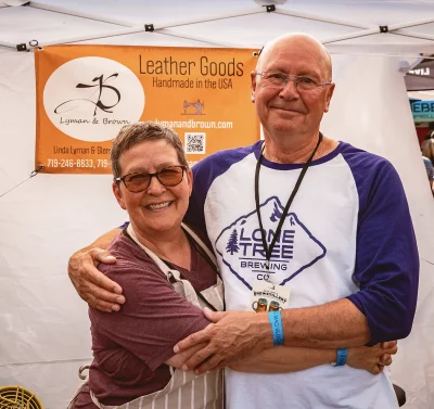 A couple posing in front of a maker tent.