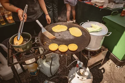 A large cast-iron pan with pancakes on it.