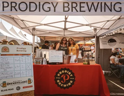 Two people working the Prodigy Brewing Tent.