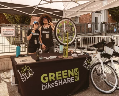 A picture of two people working at the Green bikeSHARE booth at Brewstillery.