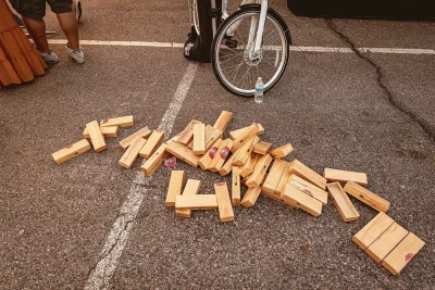 A collapsed jenga tower in a parking lot.