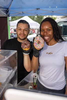Byron and Kandi Tesen pose with two donuts from the bakery.