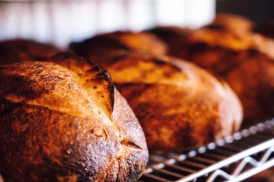 Three loaves of sourdough on a bread rack at Table X.