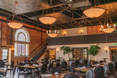 The interior of Caffé Molise, decorated with exposed brick walls, modern hanging lights, and velvet furnishings.