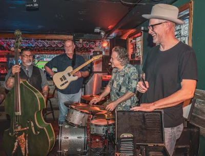 The Howlin' Tomcats stand with their instruments.