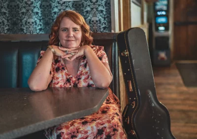 Portrait of Megan Blue seated in a booth.