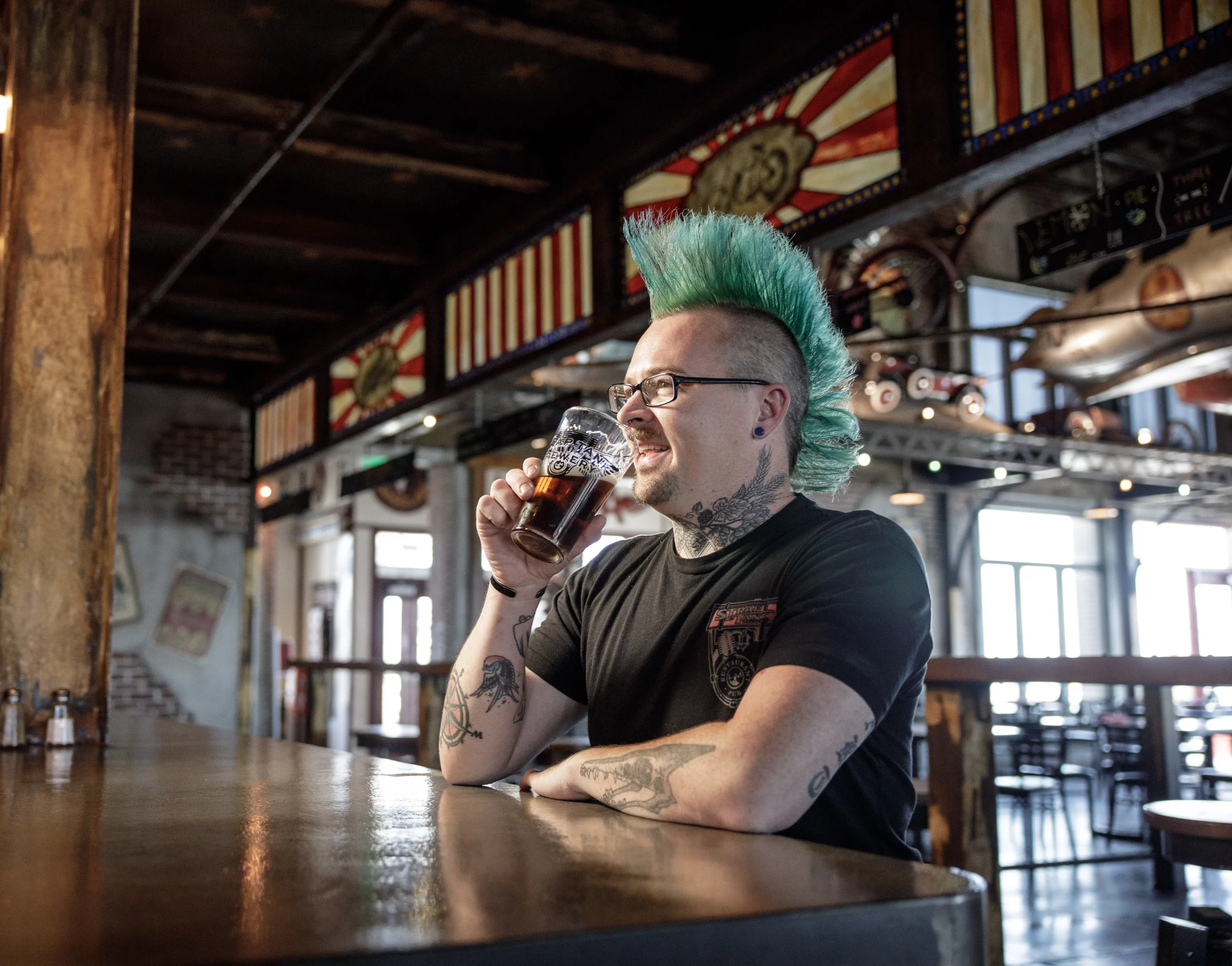 Image of brewmaster Derik DeBoard sitting at the Strap Tank bar.