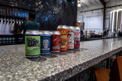 Several cans of Silver Reef Brewing Co. beer sit on a marble countertop inside the brewery. Photo: Randy Roberts 