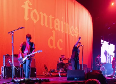 A shot of a stage with the band Fontaines D.C. warming up for their set.