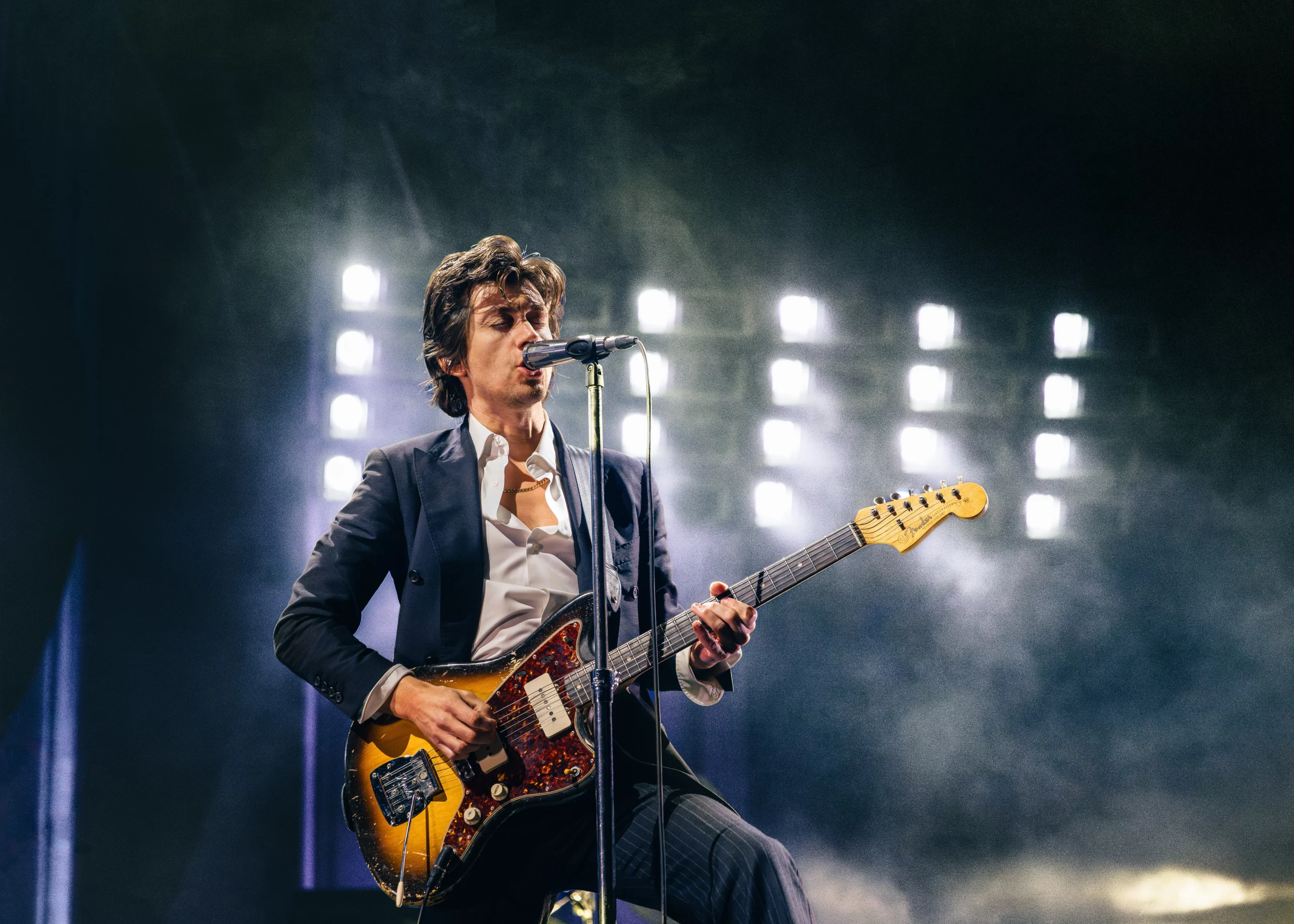 The lead singer of the Arctic Monkeys, Alex Turner singing and playing guitar.