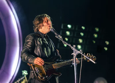 Jamie Cook playing bass for Arctic Monkeys at the Delta Center.