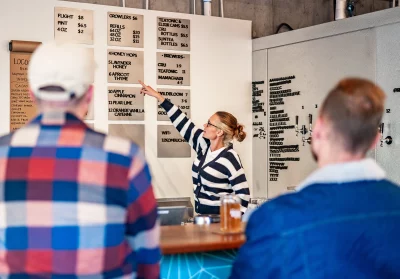 A woman points to items on the menu at Renourish Kombucha.