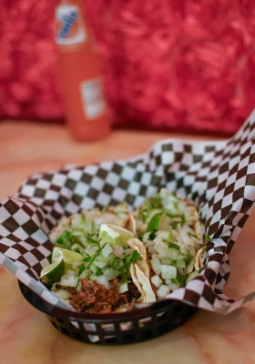 Tacos sit in a basket with checkered paper at Tacos Don Rafa.