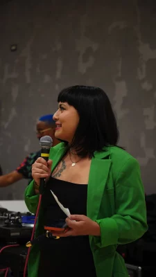 Bianca Velasquez speaking into a microphone.