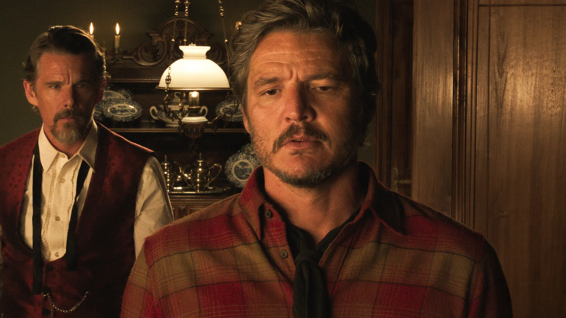 A still from Strange Way of Life with Pedro Pascal in the center. Behind him is Ethan Hawke.