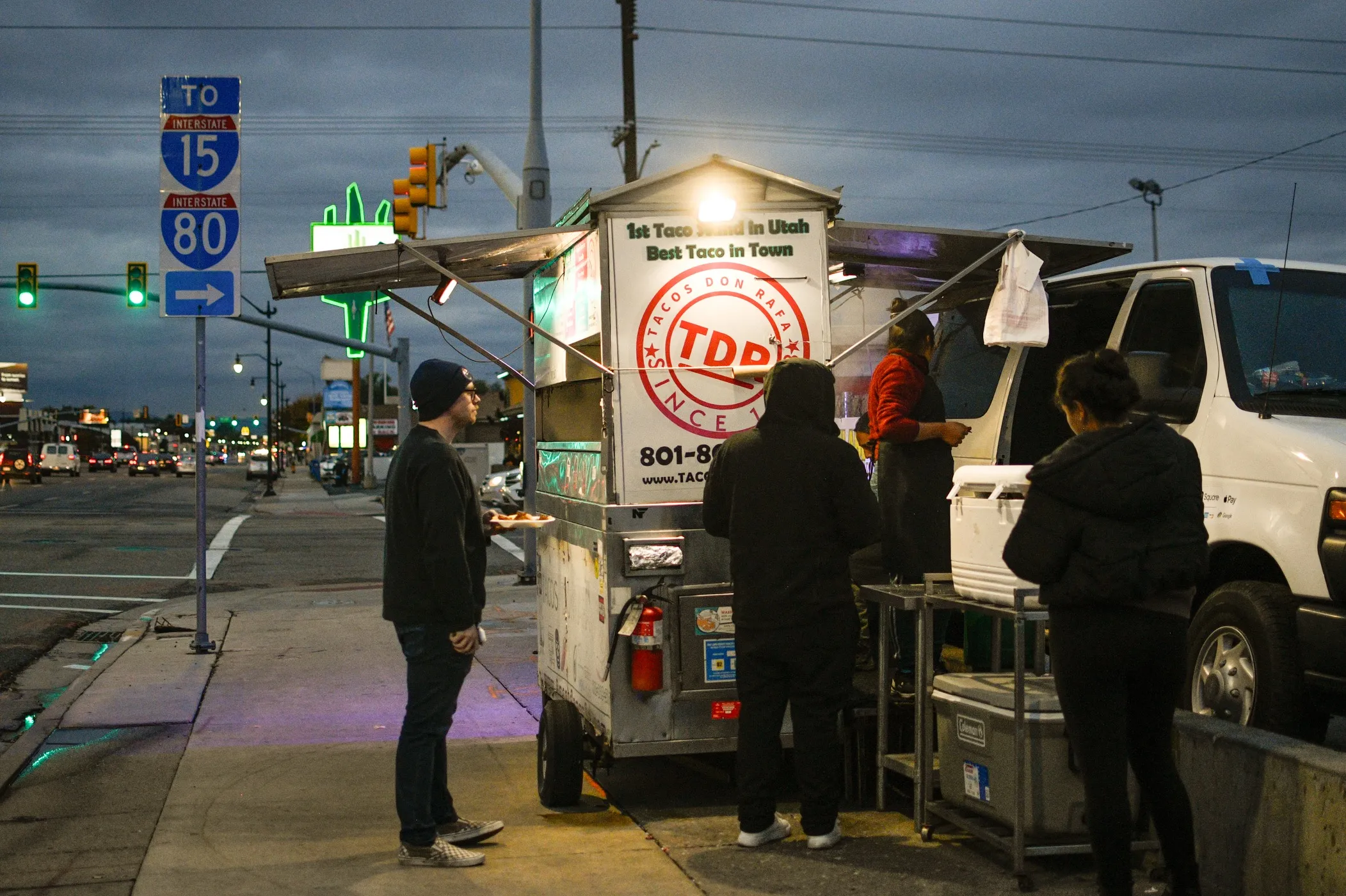 A photo of a patron at Tacos Don Rafa's taco cart location on State St. and 800 South in SLC.