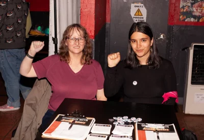 Members of armed queers salt lake in charge of the table of sign ups and swag and flyers showing what they’re about. Photo: Abel Cayas