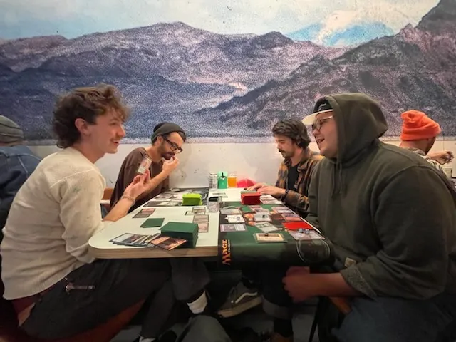 Magic: The Gathering players gathered around a table at Blue Gene's.