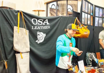 The owner of Osa Leather speaks to customers.