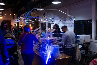 Market visitors order baked goods at a merchant booth.